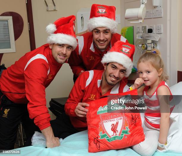 Joe Cole, Sebastian Coates and Luis Suarez of Liverpool FC visit Alder Hey Children's Hospital on December 12, 2012 in Liverpool, England.