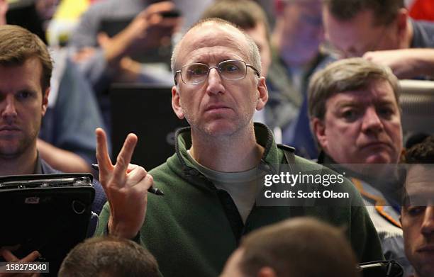 Trader signals an offer in the Standard & Poor's 500 stock index options pit at the Chicago Board Options Exchange following the Federal Open Market...