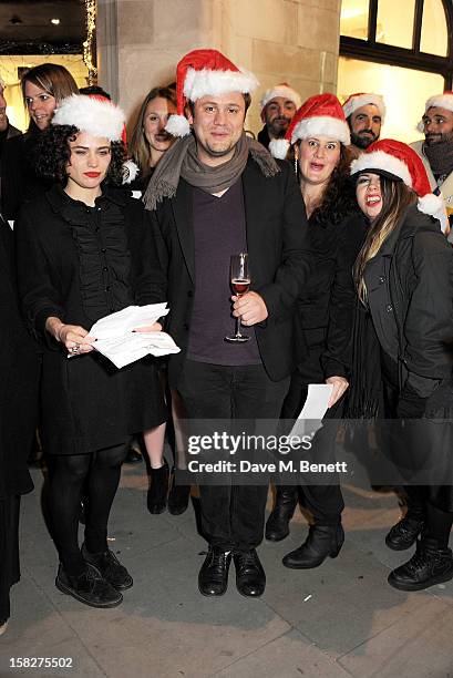 Nicholas Kirkwood poses with The Bistotheque Choir at a Christmas drinks hosted by designer Nicholas Kirkwood to celebrate his partnership with...