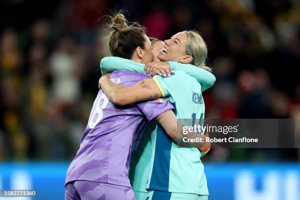 Mackenzie Arnold and Alanna Kennedy of Australia celebrate the team's 4-0 victory and qualification for the knockout stage following the FIFA Women's...