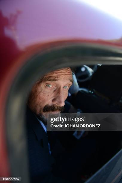 Anti-virus software pioneer John McAfee is transferred in a migration's car of Migration to the Aurora international airport in Guatemala City on...