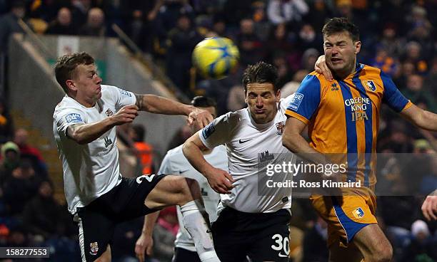 John Dempster of Mansfield Town gets in a header during the FA Cup with Budweiser Second Round replay match between Mansfield Town and Lincoln City...