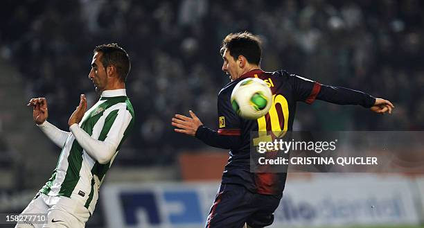 Barcelona's Argentinian forward Lionel Messi vies with Cordoba's defender Alberto Aguilar during the Spanish Copa del Rey football match Cordoba FC...