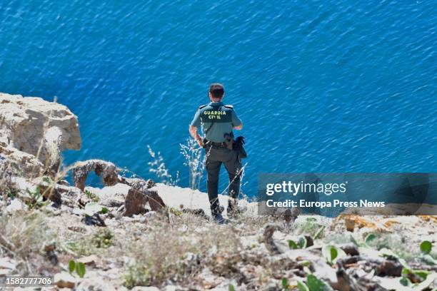 Civil Guard officer observes the coast of Ceuta after two Syrian migrants swam to the coast of Ceuta, in the Sarchal neighborhood, July 31 in Ceuta,...