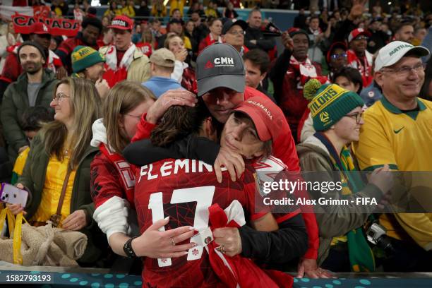 Jessie Fleming of Canada is consoled by her family after the team's 0-4 defeat and elimination from the tournament following the FIFA Women's World...