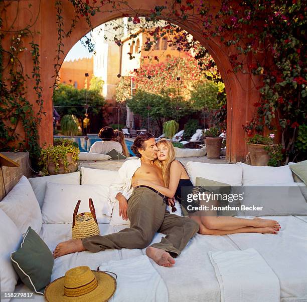 Writer Bernard-Henri Levy and wife/actress Arielle Dombasle are photographed for Vanity Fair Magazine on March 16, 2002 poolside of their eighteenth...