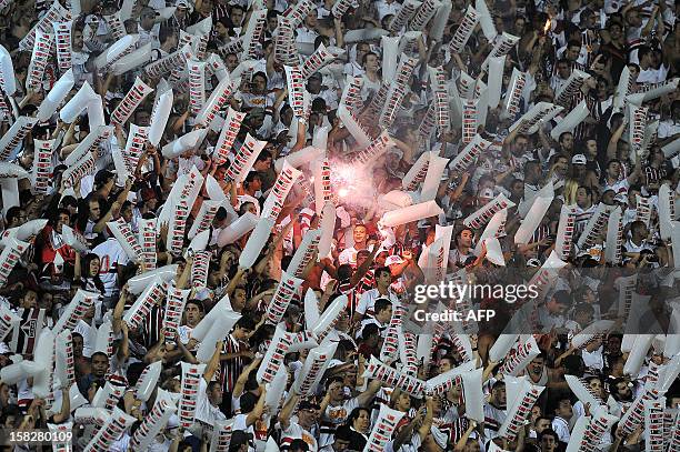 Supporters of Brazil’s Sao Paulo FC cheer for their team before their 2012 Copa Sudamericana final football match against Argentina´s Tigre held at...