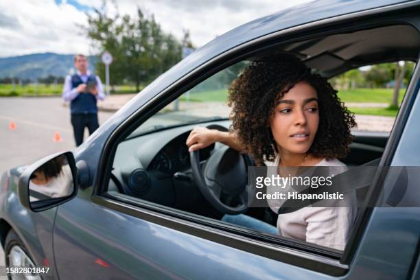 woman parallel parking on her driving test - reversing stock pictures, royalty-free photos & images