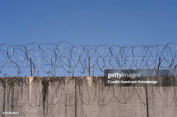 prison wall - prison fence stock pictures, royalty-free photos & images