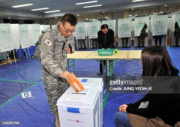South Korean soldier casts his absentee ballot for the December 19 presidential election at a polling station in Seoul on December 13, 2012. South...