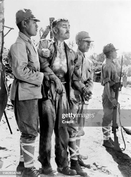 Acclaimed British actor Sir Alec Guinness performs as Col. Nicholson during the shooting of the movie "The Bridge Over the River Kwai" directed by...