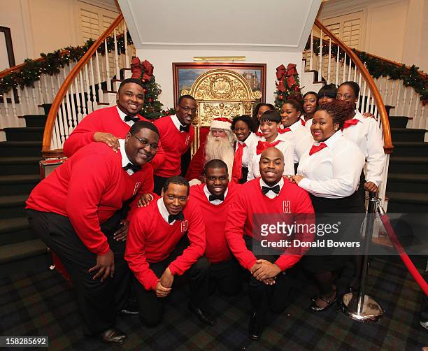 The Boys and Girls Choir of Harlem Alumni Ensemble pose with Santa Claus during The Brooks Brothers Hosts Seventh Annual Holiday Celebration To...