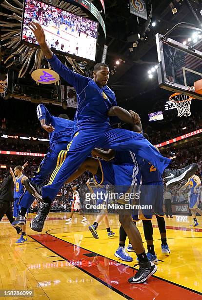 The Golden State Warriors celebrate after winning a game against the Miami Heat at American Airlines Arena on December 12, 2012 in Miami, Florida.