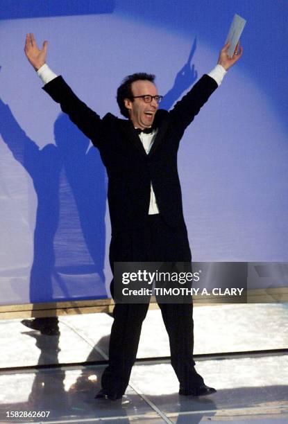 Italian director Roberto Benigni arrives on the stage to present the Oscar for Best Performance by an Actress in a Leading Role during the 72nd...