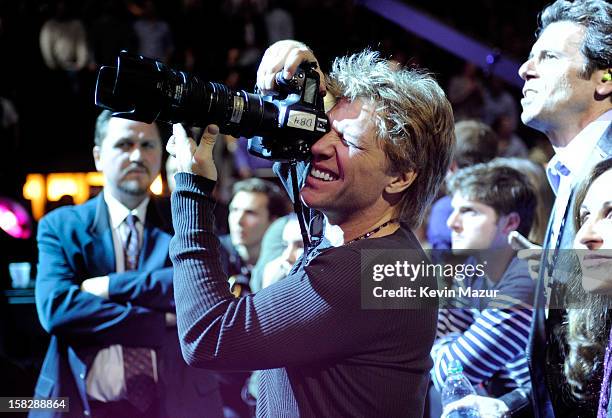 Jon Bon Jovi takes photo during "12-12-12" a concert benefiting The Robin Hood Relief Fund to aid the victims of Hurricane Sandy presented by Clear...