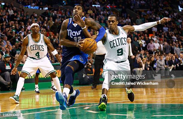Mayo of the Dallas Mavericks has the ball knocked out of his hands by Rajon Rondo of the Boston Celtics in overtime during the game on December 12,...