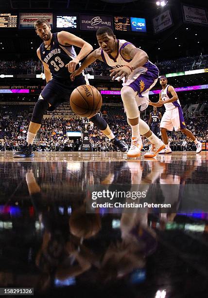 Markieff Morris of the Phoenix Suns reaches for a loose ball under pressure from Marc Gasol of the Memphis Grizzlies during the NBA game at US...