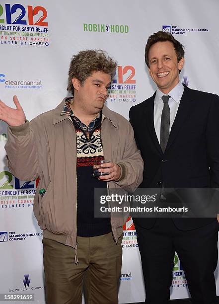 Bobby Moynihan and Seth Meyers attend "12-12-12" a concert benefiting The Robin Hood Relief Fund to aid the victims of Hurricane Sandy presented by...