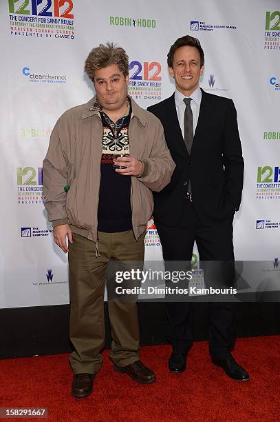 Bobby Moynihan and Seth Meyers attend "12-12-12" a concert benefiting The Robin Hood Relief Fund to aid the victims of Hurricane Sandy presented by...