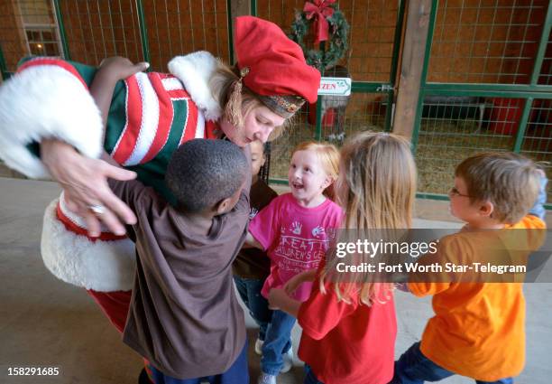 Roberta Smith gets hugs from kids after their tour of the Double R Reindeer Ranch in Midlothian, Texas, on December 4, 2012.