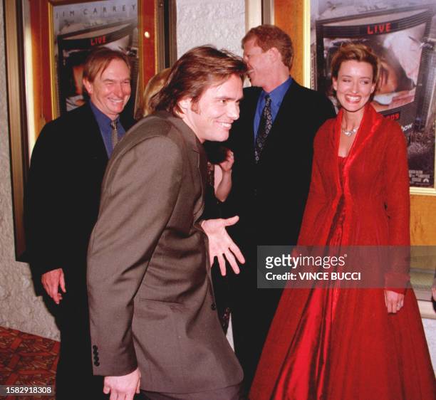 Actor-comedian Jim Carrey clowns around with cast members at the premiere of his new film "The Truman Show" 01 June in Westwood, CA. Carrey stars in...
