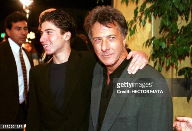 Actor Dustin Hoffman poses with his son as they arrive at Mann's Village Theater in Westwood, CA for the premier of the movie "Sphere" 11 February....