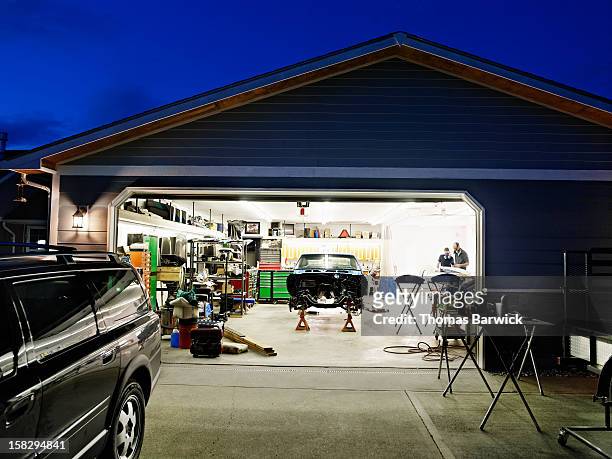 garage at night with car restoration project - auto repair shop exterior stock pictures, royalty-free photos & images