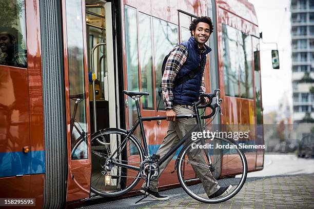 a man bike commuting. - tram fotografías e imágenes de stock