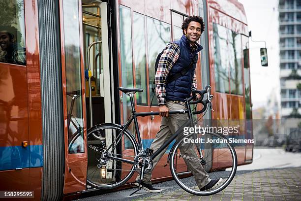 a man bike commuting. - tram stock pictures, royalty-free photos & images