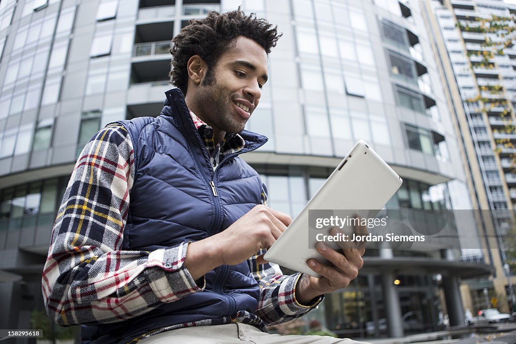 A man on his digital tablet.