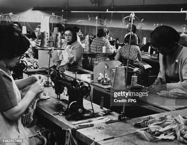 Sewing machine operators in a factory in the Garment District of Manhattan, New York City, New York, circa 1955.