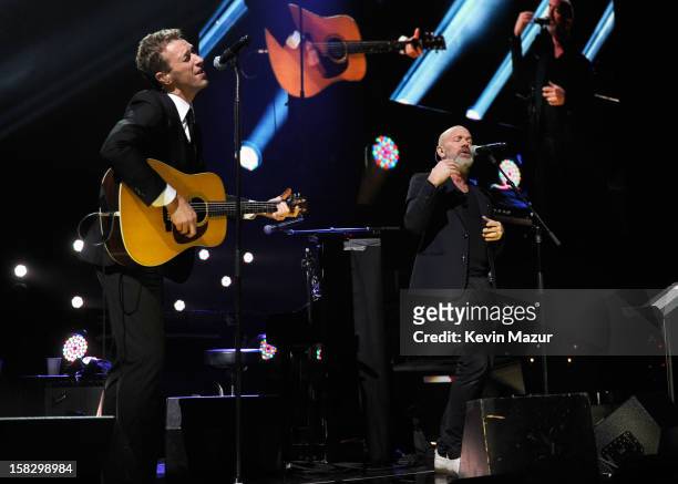 Chris Martin and Michael Stipe perform at "12-12-12" a concert benefiting The Robin Hood Relief Fund to aid the victims of Hurricane Sandy presented...