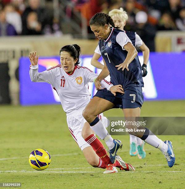 Pu Wei of China holds off Shannon Boxx of the United States in the second half at BBVA Compass Stadium on December 12, 2012 in Houston, Texas. USA...