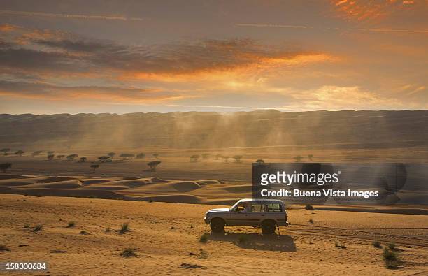 four wheel driving in a desert - oman stockfoto's en -beelden