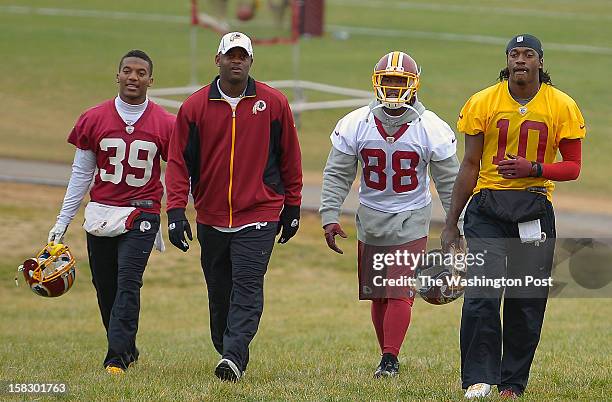 To R: Washington Redskins' cornerback Richard Crawford, receivers coach Ike Hilliard, wide receiver Pierre Garcon, and quarterback Robert Griffin III...