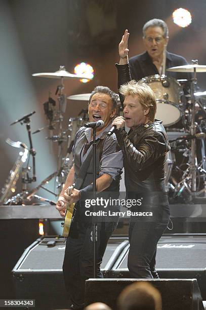 Bruce Springsteen and Jon Bon Jovi perform during "12-12-12" a concert benefiting The Robin Hood Relief Fund to aid the victims of Hurricane Sandy...