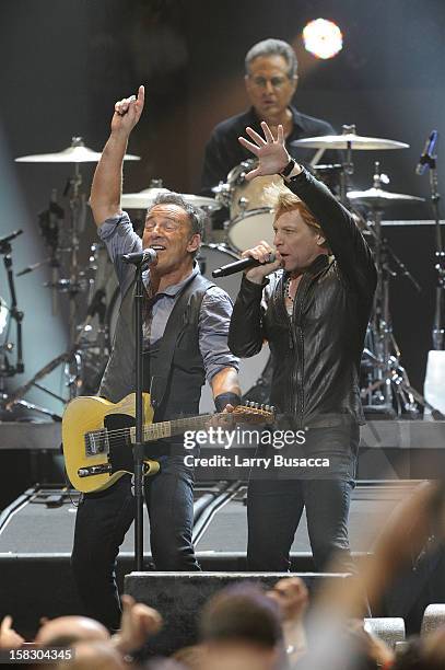 Bruce Springsteen and Jon Bon Jovi perform during "12-12-12" a concert benefiting The Robin Hood Relief Fund to aid the victims of Hurricane Sandy...