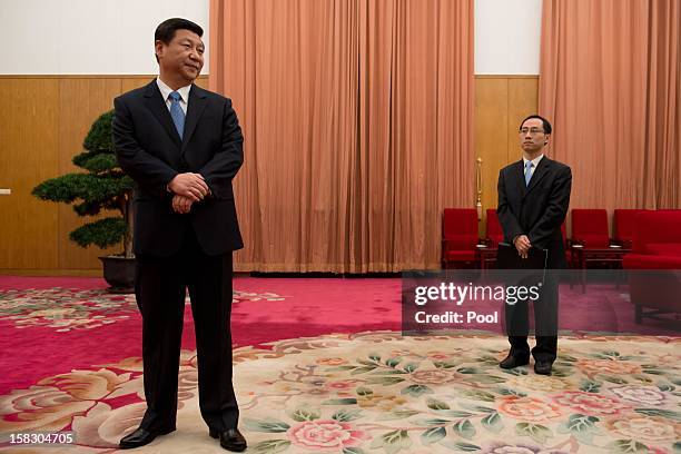 Communist Party leader Xi Jinping waits to greet former US President Jimmy Carter in room 202 of the Zhongnanhai leadership compound on December 13,...