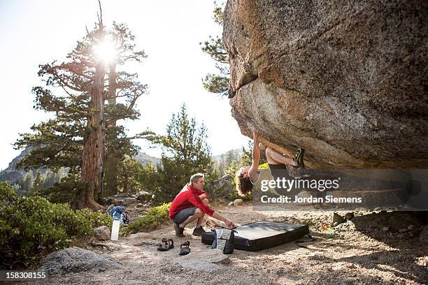 two men bouldering. - bouldering stock pictures, royalty-free photos & images