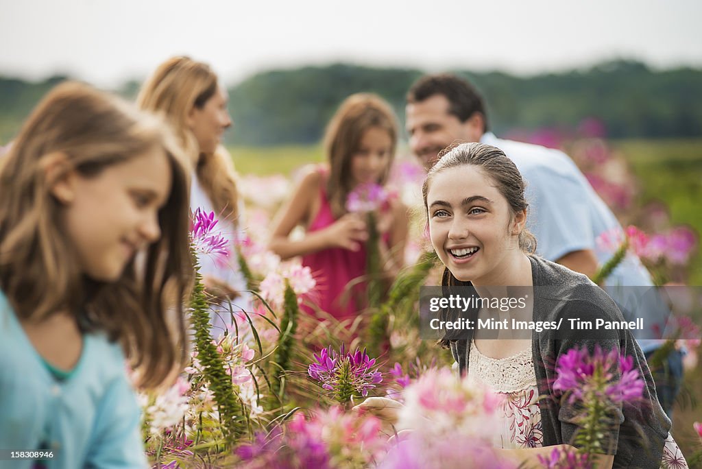 A group of people among the flowers at an organic Flower Farm.