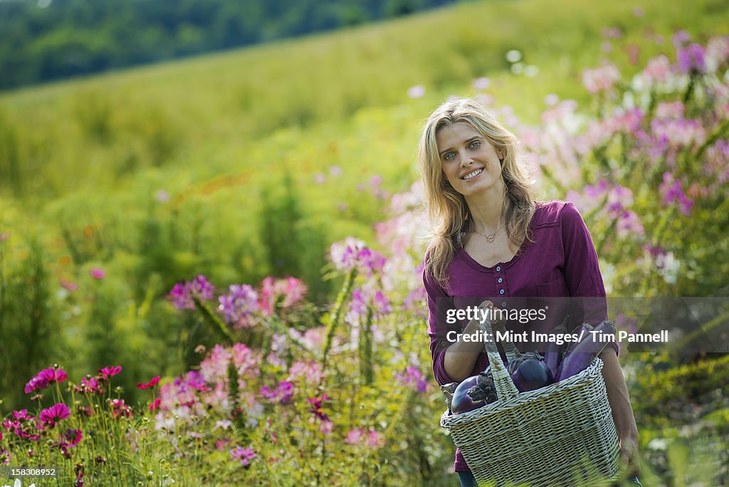 A woman in a garden full of flowers on an organic flower farm.