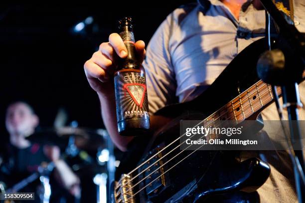 Chris Batten of Enter Shikari Performs onstage showing off the bands beer during a day of the 5th UK leg of their A Flash Flood of Colour World Tour...