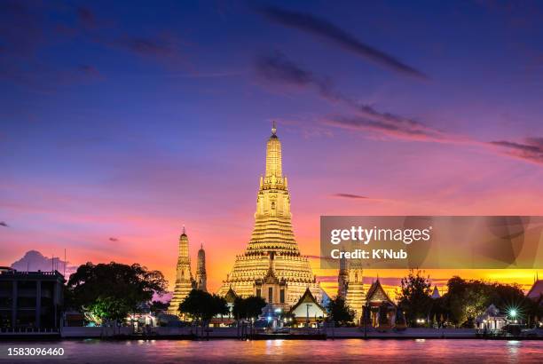 sunset view of golden stupa buddha temple name wat arun, along chao phraya river the most famous landmark and travel destination in center of bangkok city, thailand, south east asia - k'nub stock pictures, royalty-free photos & images