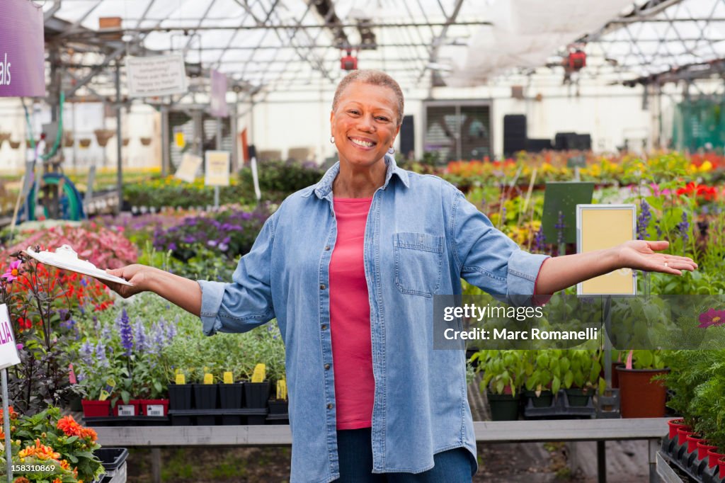 Mixed race woman working in plant nursery