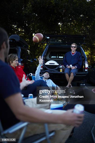 a group of friends at a barbeque or tailgate party at an event. - tailgate party stock pictures, royalty-free photos & images