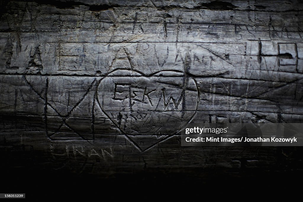 A heart shape carved into seasoned timber, with a romantic message.