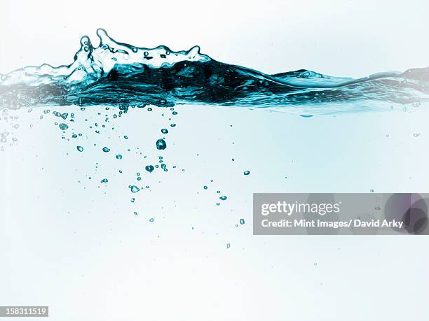 liquid in a container, with moving water and air bubbles. - water splash white background stock illustrations