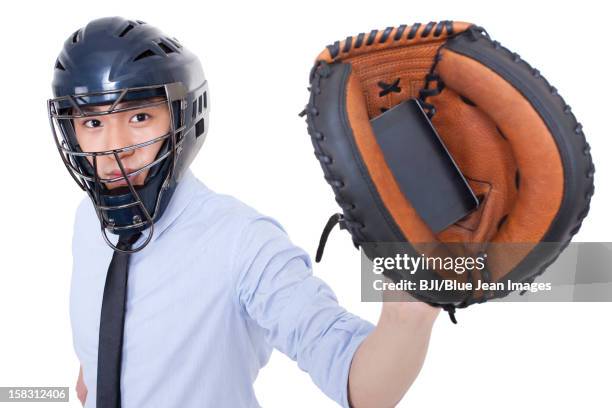 businessman catching a smart phone - baseball glove stock pictures, royalty-free photos & images