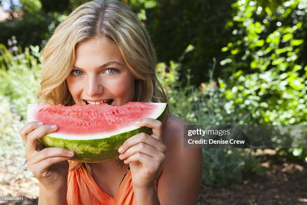 Caucasian girl eating watermelon