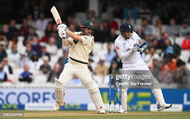 Travis Head of Australia plays a shot as England Wicketkeeper Jonny Bairstow looks on during Day Five of the LV= Insurance Ashes 5th Test Match...